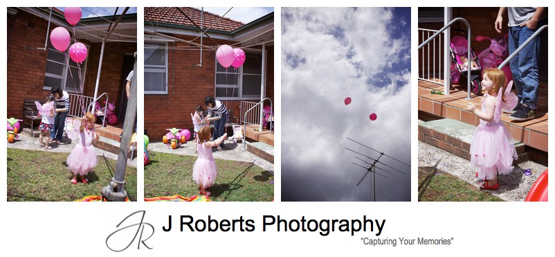 Birthday girl letting go of pink helium balloons at birthday party - sydney party photography